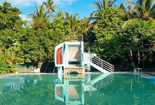 a slide in the middle of a swimming pool at Cadaya Resorts 