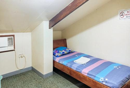 a small bedroom with a bed in a attic at Cadaya Resorts 