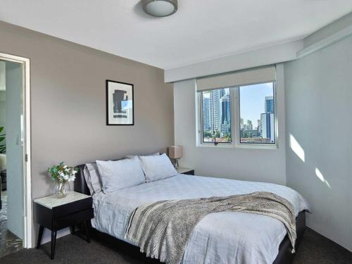 a bedroom with a large bed and a window at Quiet location close to it all in Gold Coast
