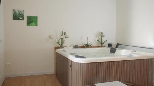 a bath tub in a room with a sink at Hôtel Beau Soleil in Le Lavandou