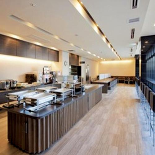 a restaurant with a counter in a room at Smile Hotel Kokura in Kitakyushu