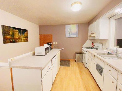 a kitchen with white cabinets and a white counter top at Express Gateway in Stevens Point in Stevens Point