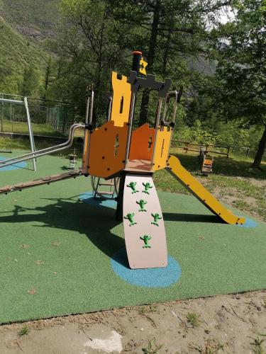 a playground with a slide in a park at Chalet del paese Incantato comune di Moncenisio in Moncenisio