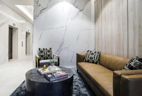 a living room with a couch and a table at Brand-New Central Studio Apart with Views in Brisbane