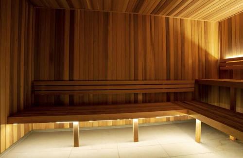 a row of wooden benches in an empty room at Brand-New Central Studio Apart with Views in Brisbane
