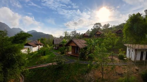 an aerial view of a village in the mountains at Naga Lodge in Luang Prabang