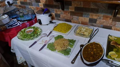 a table with plates of food on top of it at Chez Benoit Self Catering in Victoria