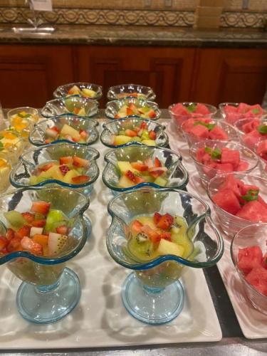 a table topped with bowls of fruit in glass dishes at Holiday Inn Al Khobar by IHG in Al Khobar