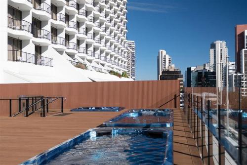 a swimming pool on the roof of a building at Amazing suite with beach views at prime location in Gold Coast