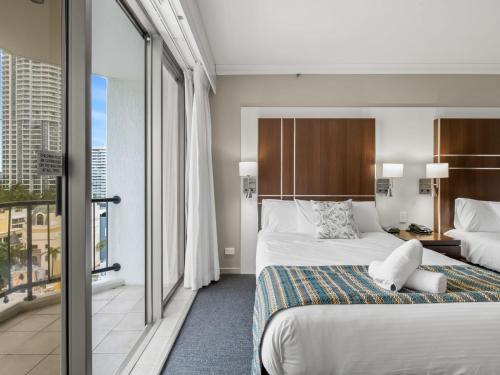 a hotel room with a bed and a balcony at Amazing suite with beach views at prime location in Gold Coast