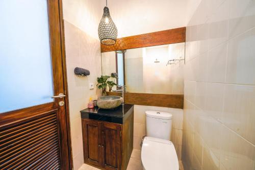 a bathroom with a toilet and a sink at OASIS 66 Villa - Heart of Legian/Seminyak - Double Six in Seminyak