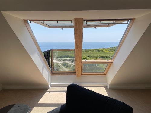 a room with a large window with a view of the ocean at Sea views in Southwell