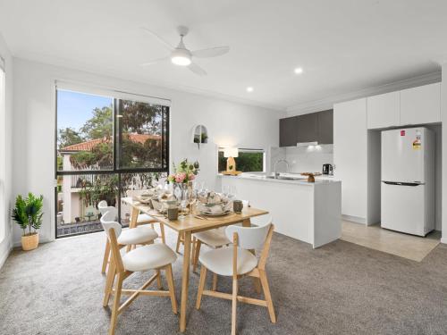 a kitchen and dining room with a table and chairs at Newly Furnished Spacious 3BR Townhouse at GC in Gold Coast