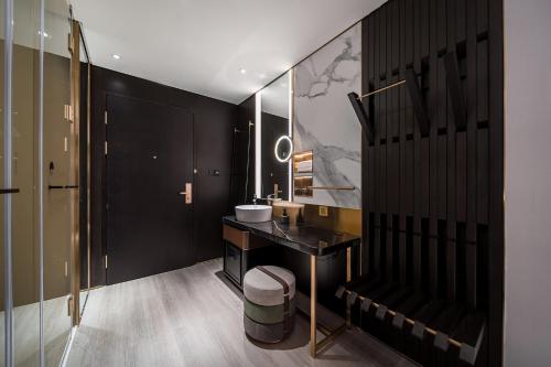 a black bathroom with a sink and a mirror at CitiGO Hotel Shenzhen Shekou Cruise Center Seaview Near Taizi Bay K11 in Shenzhen