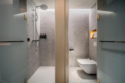 a bathroom with a shower and a toilet in it at CitiGO Hotel Shenzhen Shekou Cruise Center Seaview Near Taizi Bay K11 in Shenzhen