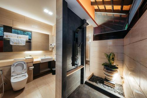 a bathroom with a toilet and a sink at Kranji Sanctuary Resort in Singapore