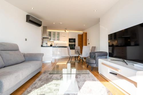 a living room with a couch and a table at Seaside Serenity Oasis - High floor - Stunning Views in Gibraltar