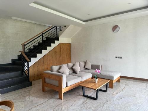 a living room with a couch and a table at Agusta Lake View Bedugul in Buleleng