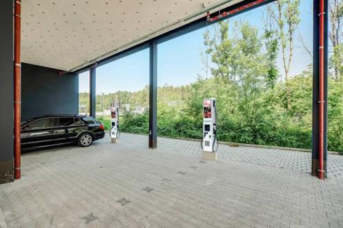 a car parked in a garage with two parking meters at BRIGHT: Rosenheim Aicherpark in Rosenheim