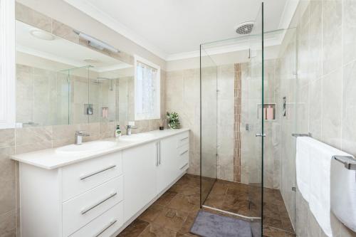 a bathroom with a sink and a shower at Spacious newly redecorated 5BD Family Home in Brisbane