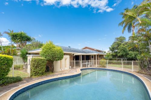 a swimming pool in front of a house at Hobbit House Inspired 4BR cozy Fairytale Cottage in Brisbane