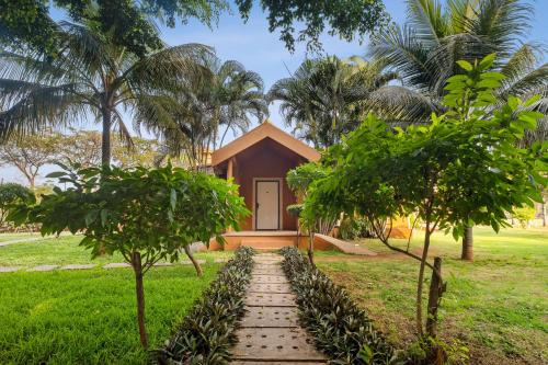 a small house with a pathway leading to it at Vijayshree Resort, Hampi in Hampi