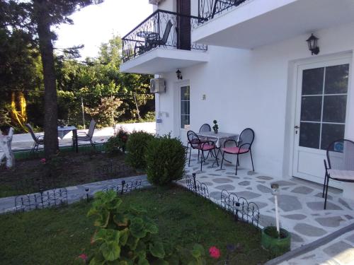 a patio with a table and chairs in a yard at Villa Ourania in Troulos