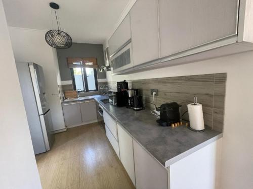 a kitchen with white cabinets and a counter top at Villa Coco in Trou aux Biches
