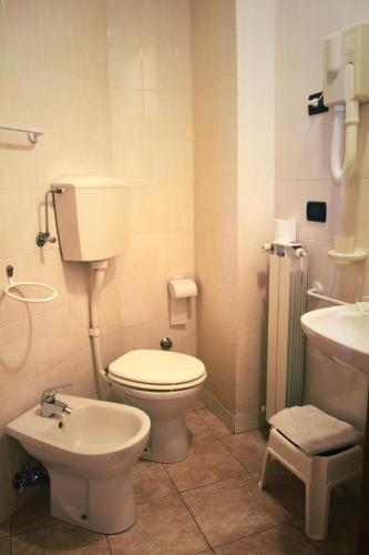a bathroom with a toilet and a sink at Hotel Mary in La Spezia