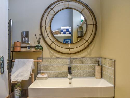 a bathroom with a large mirror and a tub at Sams Snug in Birchington
