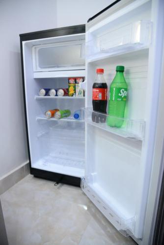 an open refrigerator filled with drinks and other items at GO Luxury Grand Hotel in Lahore