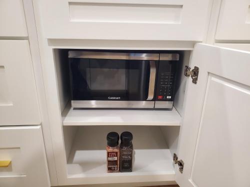 a kitchen with a microwave in a white cabinet at S&N Lux Suite-Free Parking-King Bed-Kitchen-WiFi in Honolulu