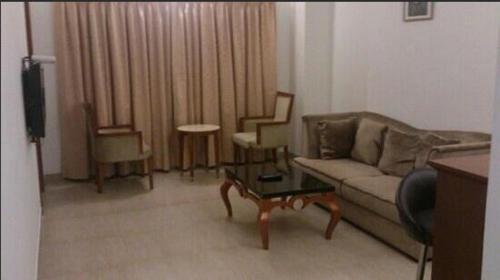a living room with a couch and chairs at Cochin Palace in Cochin