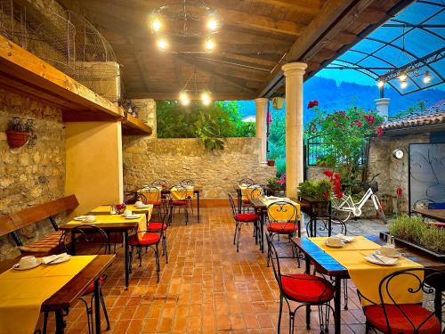 a restaurant with tables and chairs in a patio at Vila Marija in Skradin