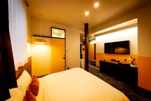 a hotel room with a bed and a sink at The Villa & Barrel Lounge in Shizuoka