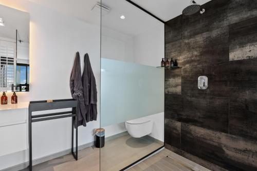 a bathroom with a glass shower and a toilet at Atholl House in Cape Town