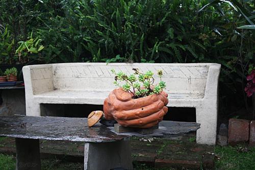 a large pumpkin sitting on a table next to a bench at Hostal Saint Mary´s Tababela in Tababela