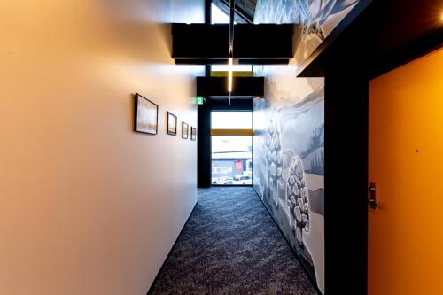 a hallway with white walls and a hallway with yellow walls at The Villa & Barrel Lounge in Shizuoka