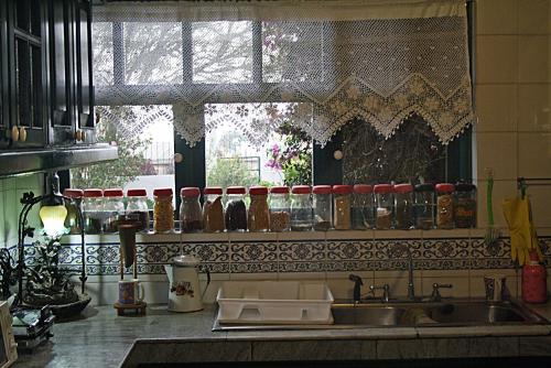 a kitchen counter with a sink and a window at Hostal Saint Mary´s Tababela in Tababela