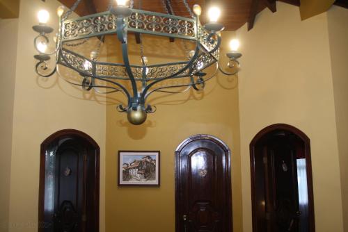 a chandelier hanging in a room with two doors at Hostal Saint Mary´s Tababela in Tababela