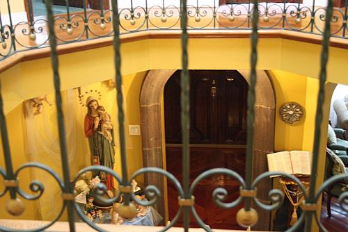 a woman is standing in front of a mirror at Hostal Saint Mary´s Tababela in Tababela