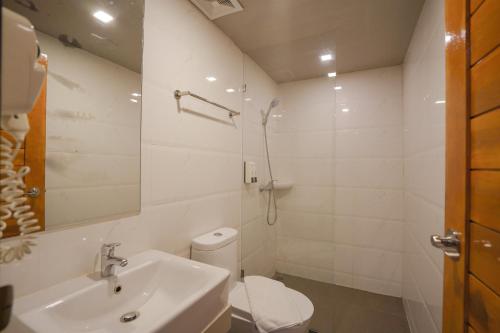 a bathroom with a sink and a toilet and a shower at Beston Pattaya - SHA Plus Certified in Pattaya South