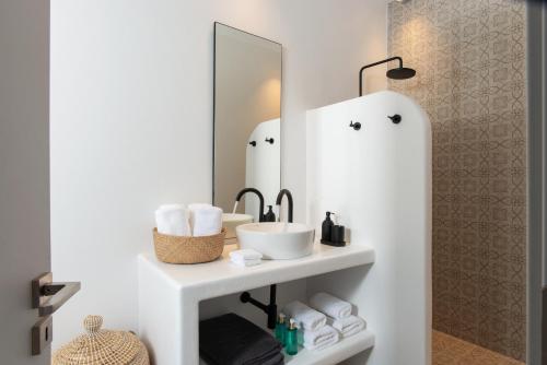 a bathroom with a sink and a mirror at Haroto Suites in Tripiti