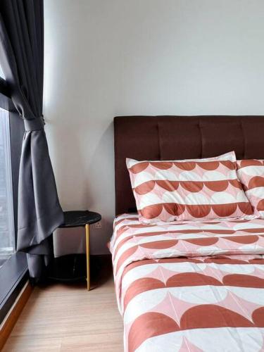a bedroom with a bed and a chair next to a window at Family Gathering with Bathtub in Icon City, 12 Pax near Bandar Sunway in Petaling Jaya