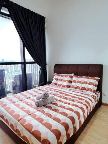 a bed with a teddy bear on top of it at Family Gathering with Bathtub in Icon City, 12 Pax near Bandar Sunway in Petaling Jaya