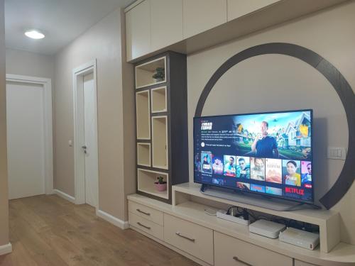 a living room with a flat screen tv on a wall at Tirana New Bazaar- Apartment no-1 in Tirana