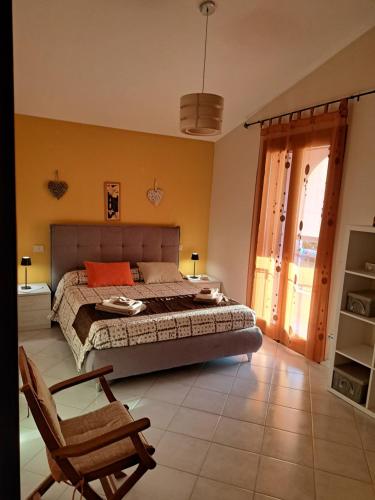 a bedroom with a bed and a chair at Casa Grace Pula in Pula