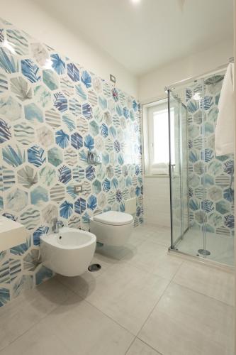 a bathroom with a toilet and a glass shower at Rosy's House in Scafati