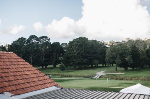 a view of a golf course from a roof at Dormie House in Moss Vale
