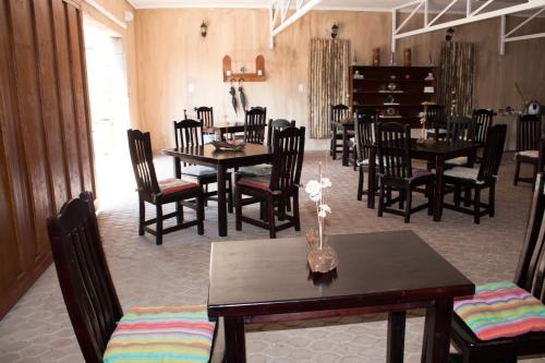 a dining room with wooden tables and chairs at 61 On Ireland in Polokwane